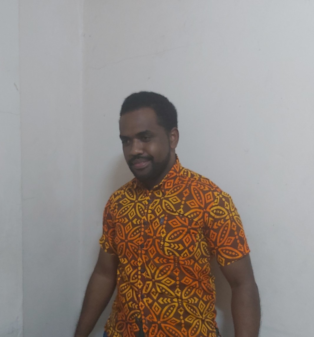 Solomoni Railoa seated at his coding workspace